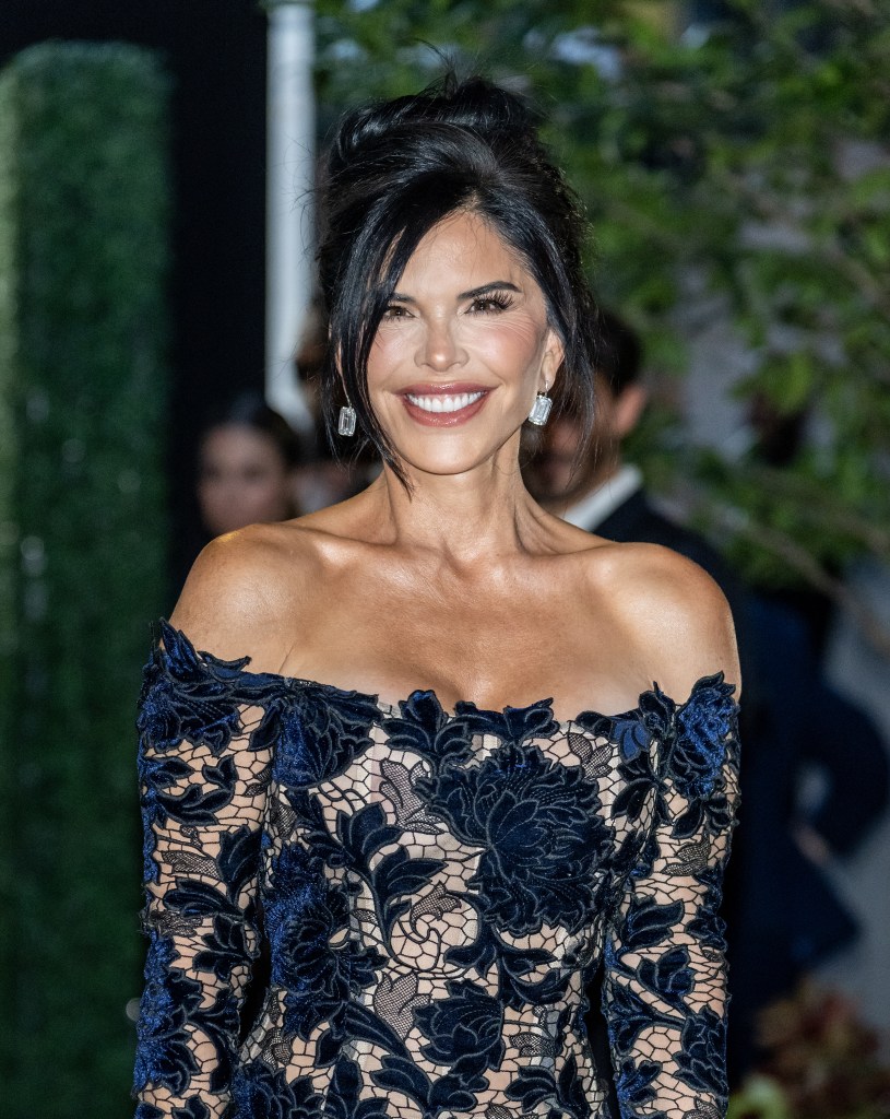 Lauren Sánchez in a navy blue, off-the-shoulder, floral lace dress.